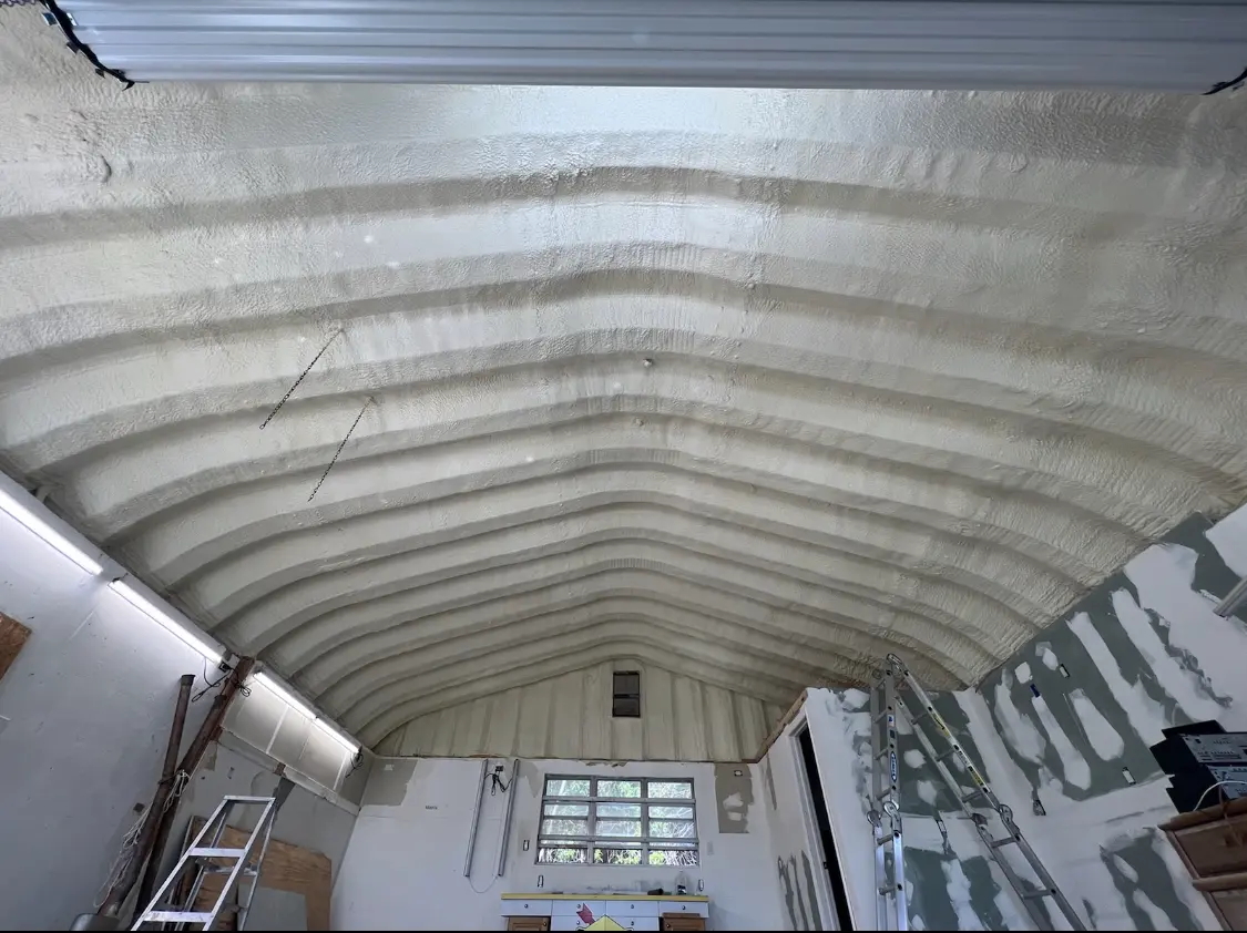 Spray polyurethane foam applied to the underside of a metal roof deck in Madras